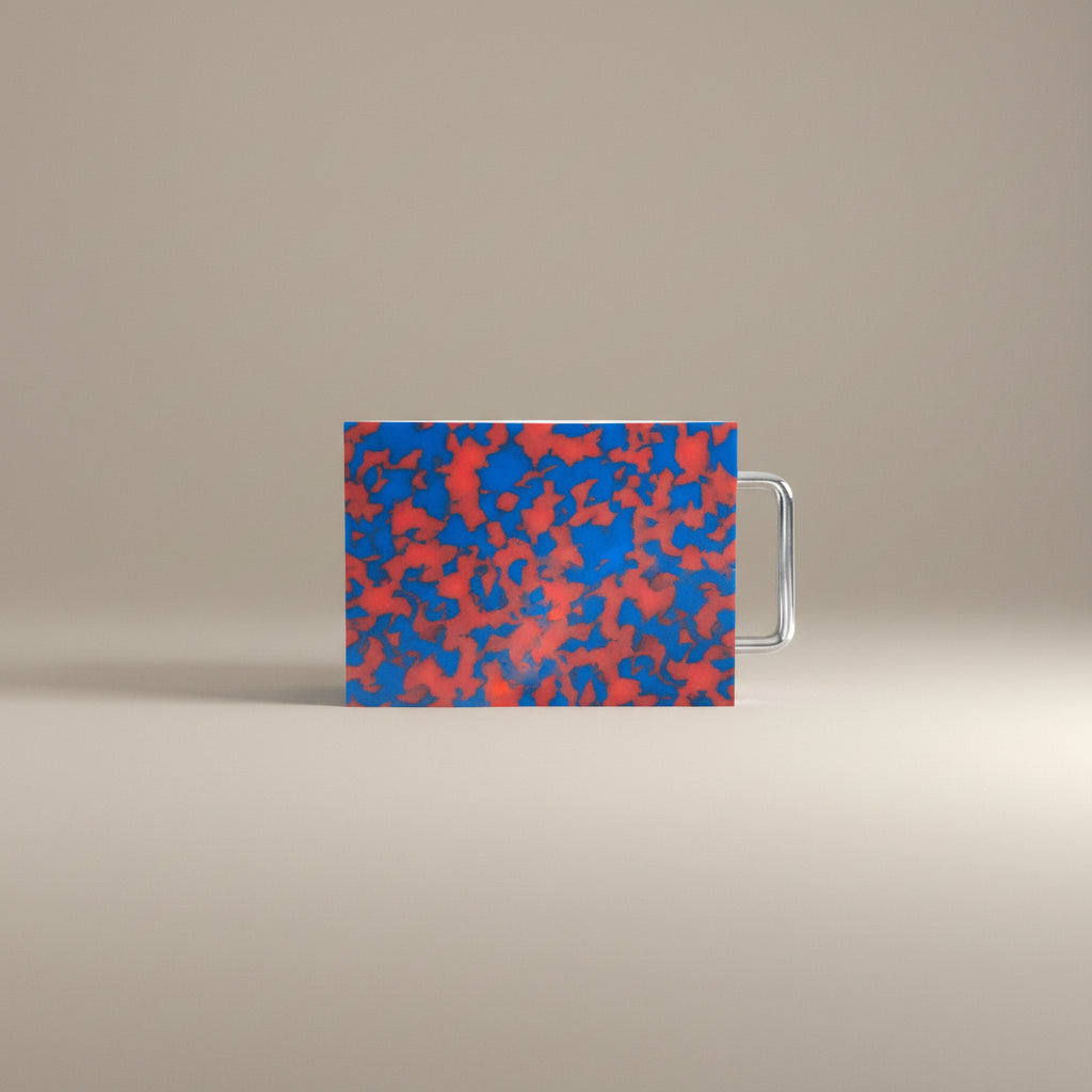 Small red and blue marbled cutting board with chrome handle on white background