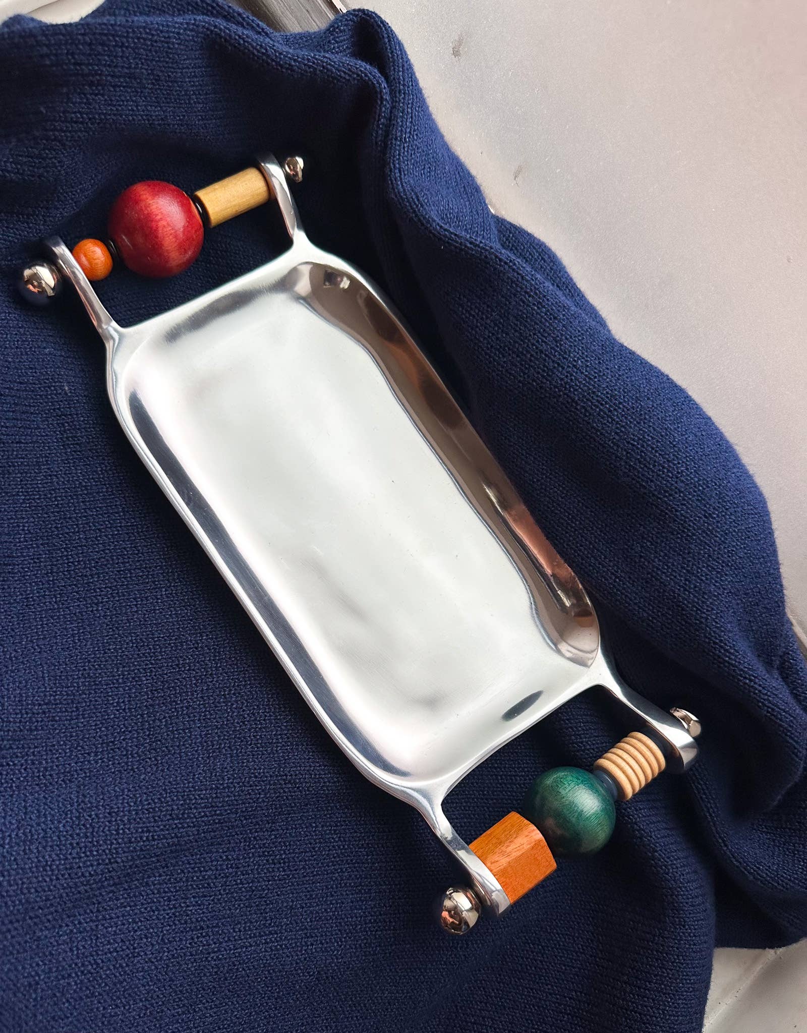 Beaded Keepsake Tray by Yam, polished stainless steel tray with twin handles strung from freshwater pearls and wooden beads