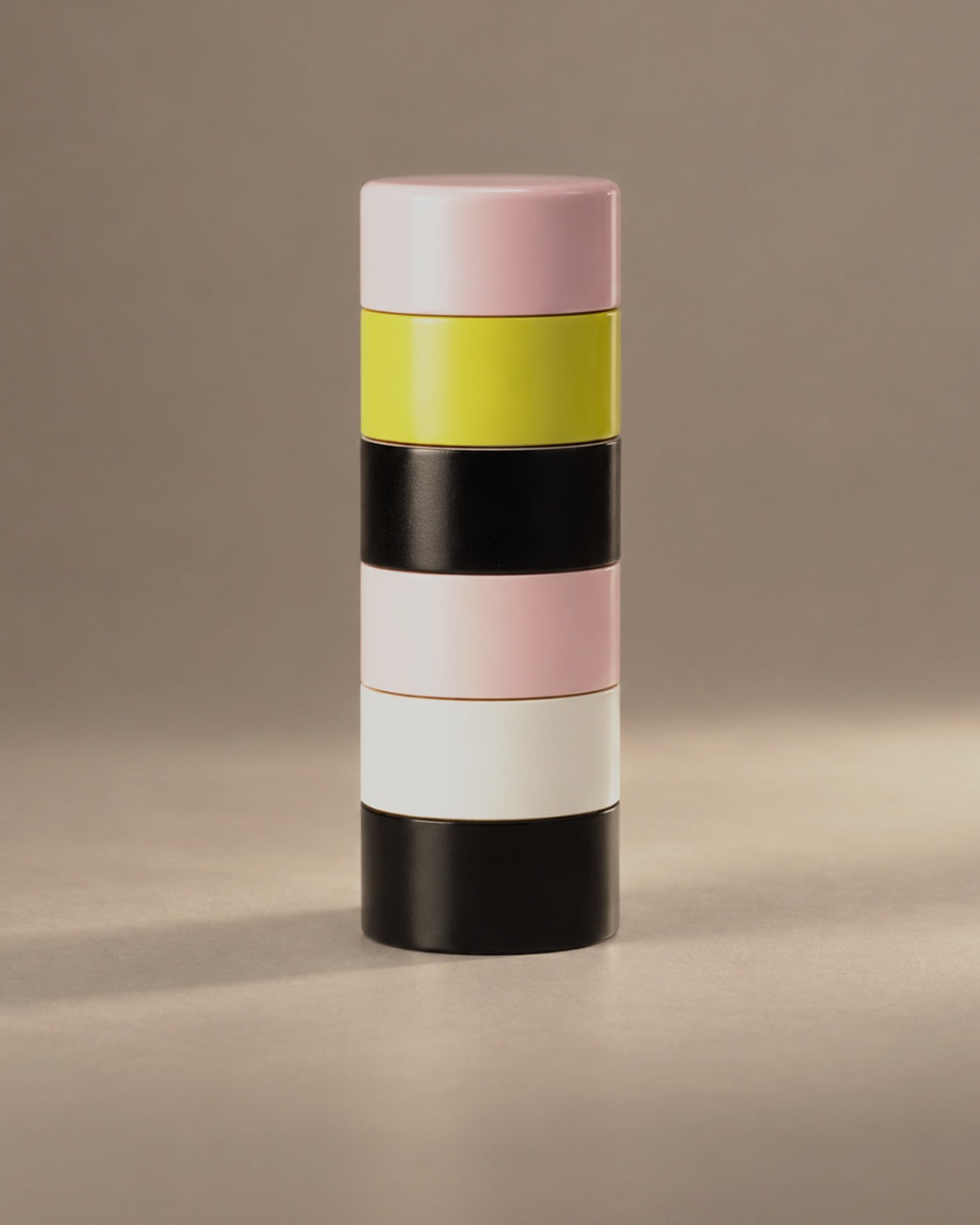 Dimes Peppermill in Pink with pink, yellow, black and white lacquered bands, photographed in the Son of Rand studio