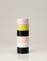 Dimes Peppermill in Pink – handcrafted wooden pepper grinder with stacked pink, yellow, black, and white segments inspired by Andre Cadere