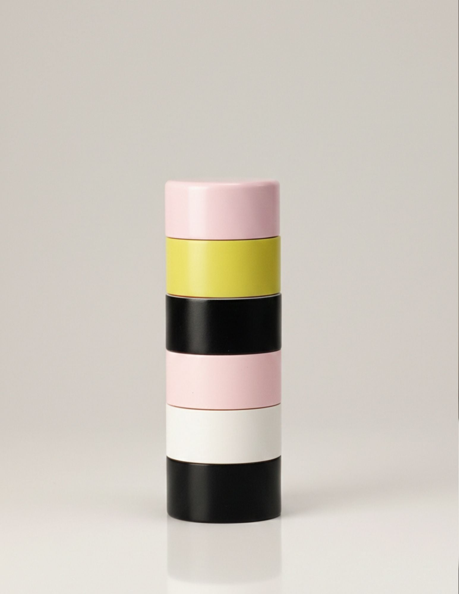 Dimes Peppermill in Pink – handcrafted wooden pepper grinder with stacked pink, yellow, black, and white segments inspired by Andre Cadere