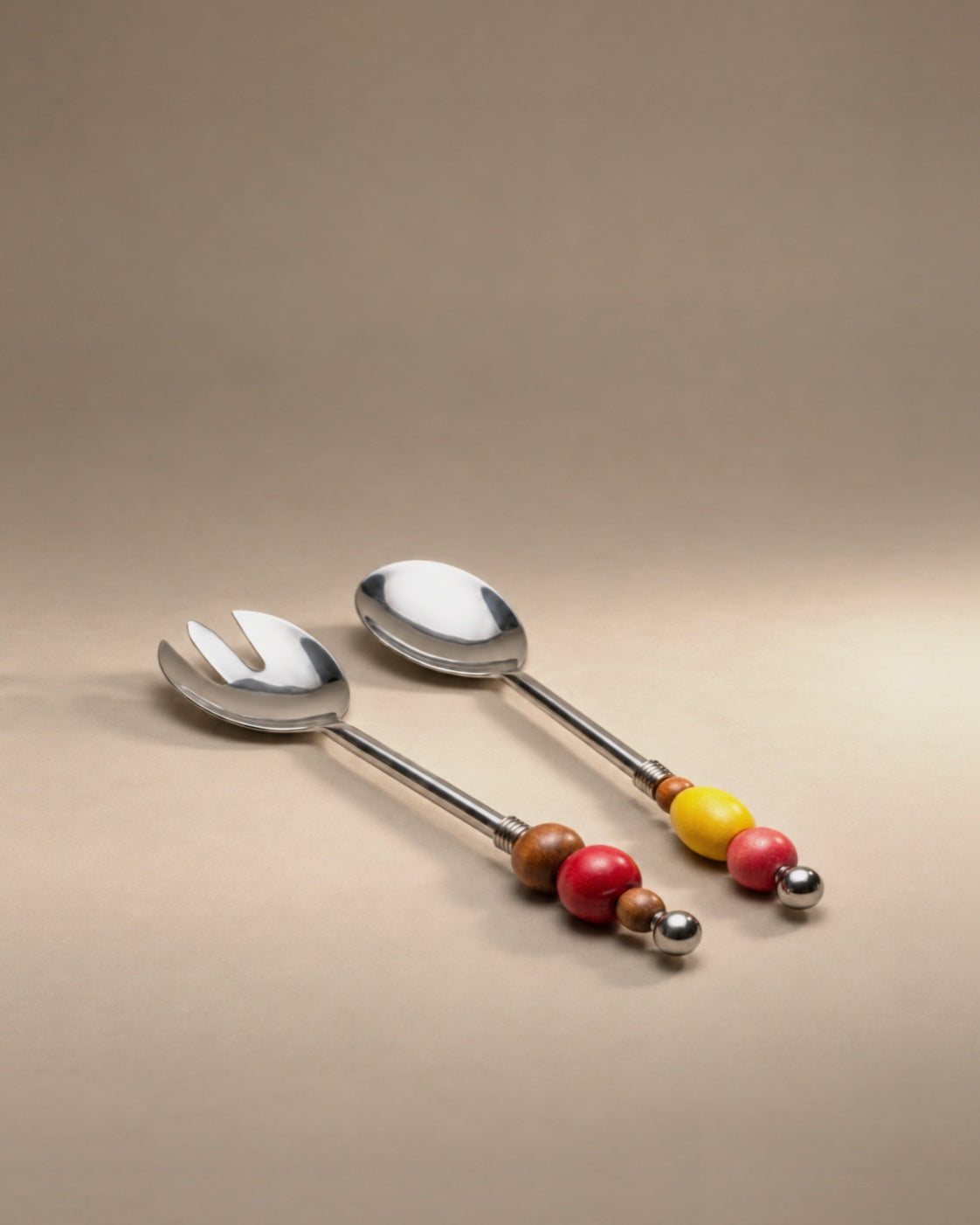 Yam beaded serving spoon and fork with red, yellow and wood beads, photographed in the Son of Rand studio