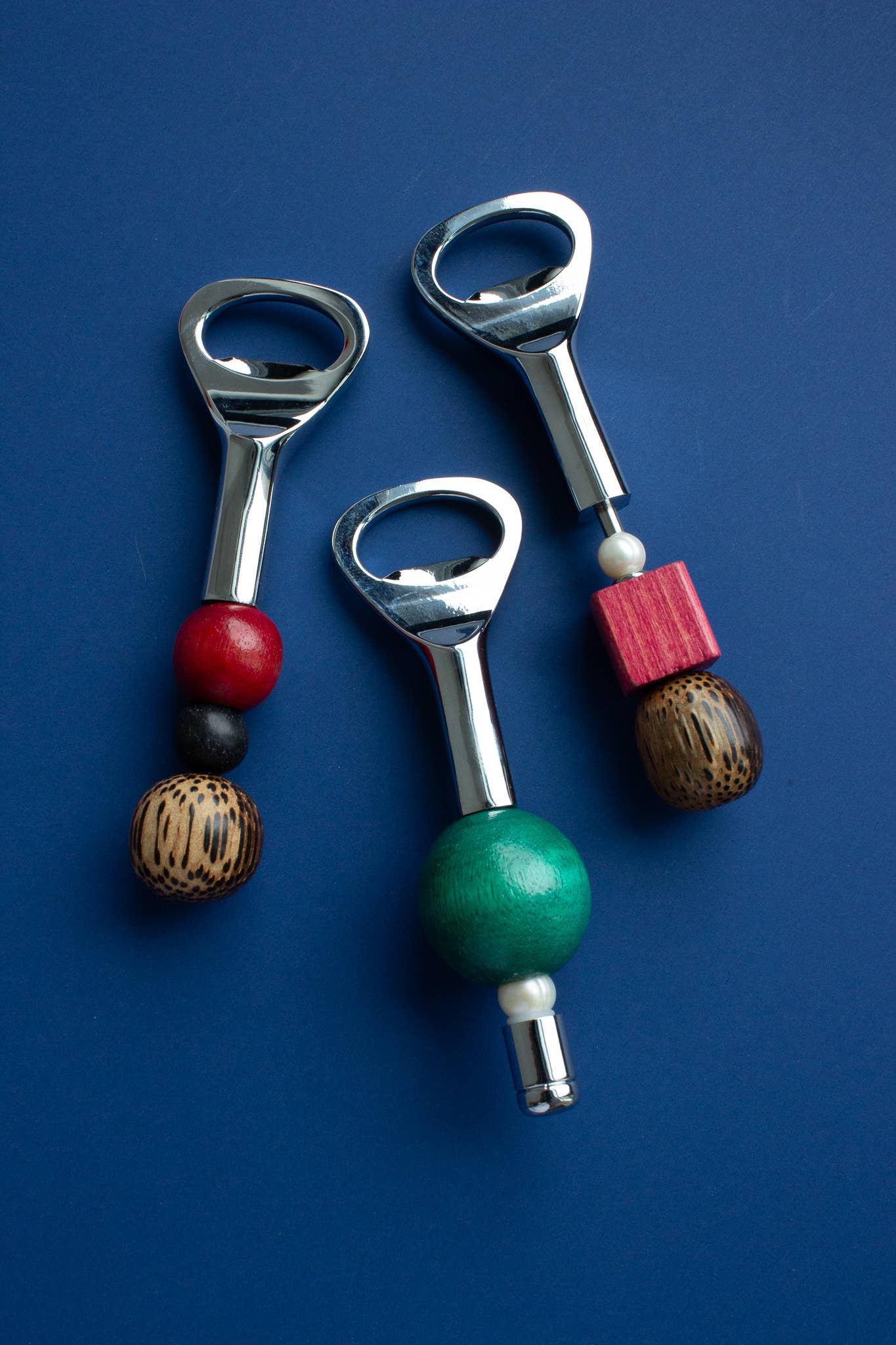 Beaded Bottle Opener by Yam, stainless steel opener with a handle strung from freshwater pearls and wooden beads