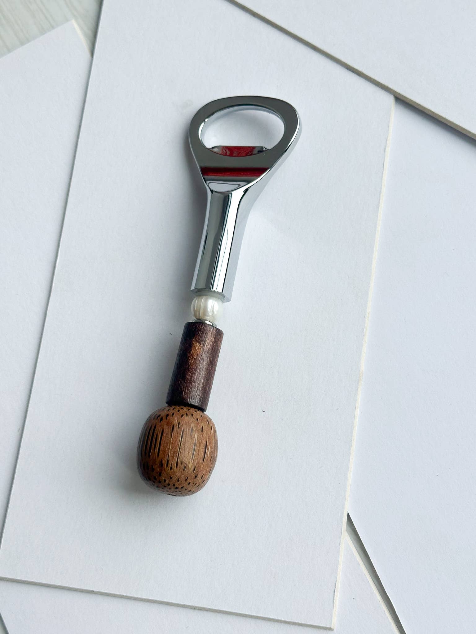 Yam Beaded Bottle Opener held in hand, showing scale and weight of the beaded handle