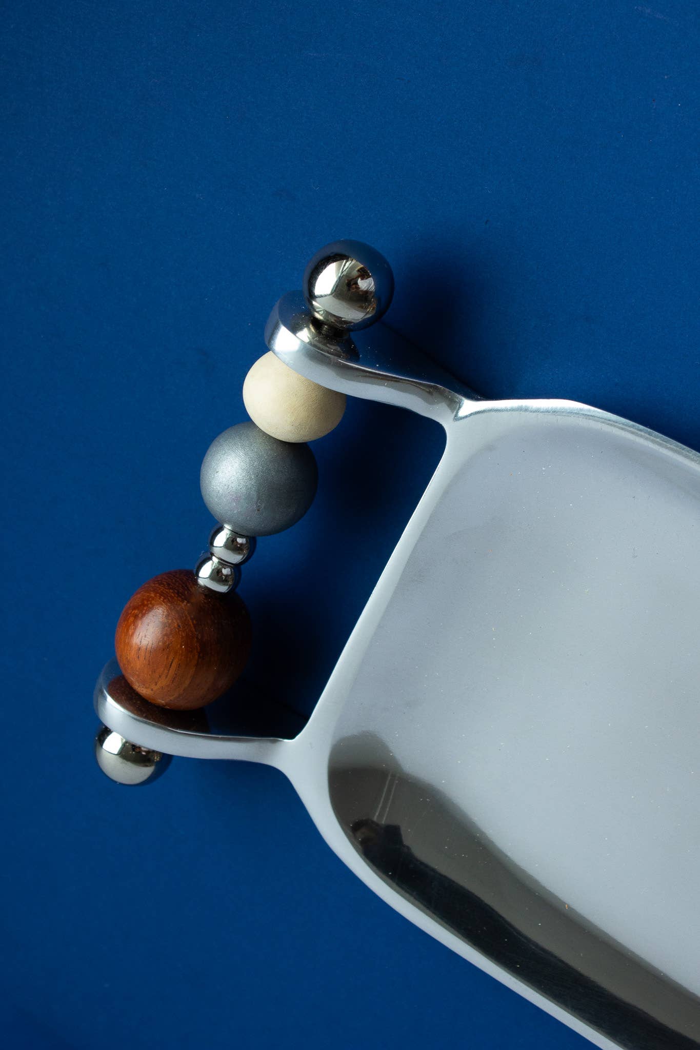 Close view of the Yam Beaded Keepsake Tray handle, hand-strung pearls and upcycled wooden beads in cream, grey and russet