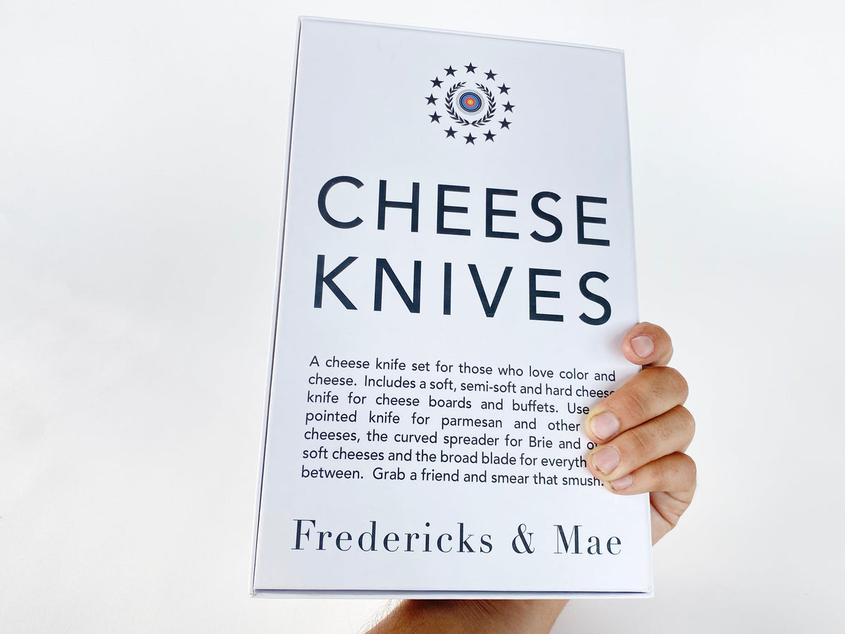Fredericks and Mae cheese knives box held in hand showing printed description