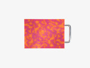 Small pink and orange marbled cutting board with chrome handle on white background