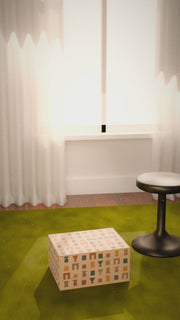 A Son of Rand Seasonal Box rises off a green rug, its tear strip peels away, the lid opens and a cutting board, tumbler, coasters and serving spoons float out