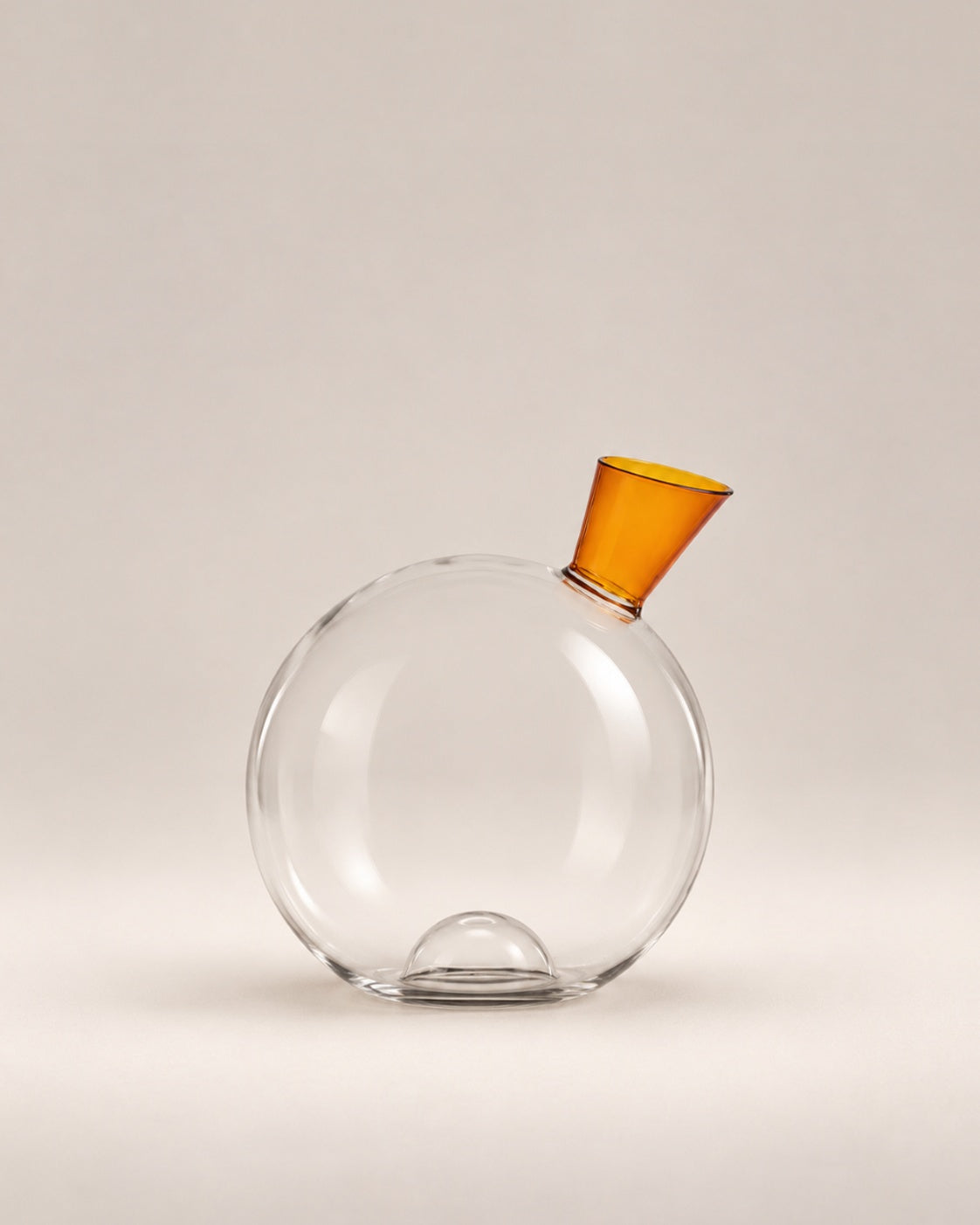 Travasi Decanter, a clear glass sphere with an amber funnel neck, photographed in the Son of Rand studio