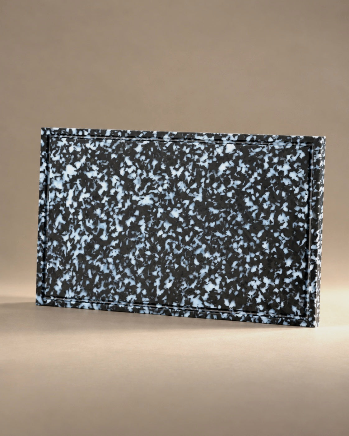 Black + White Cutting Board XL, standing upright, photographed in the Son of Rand studio