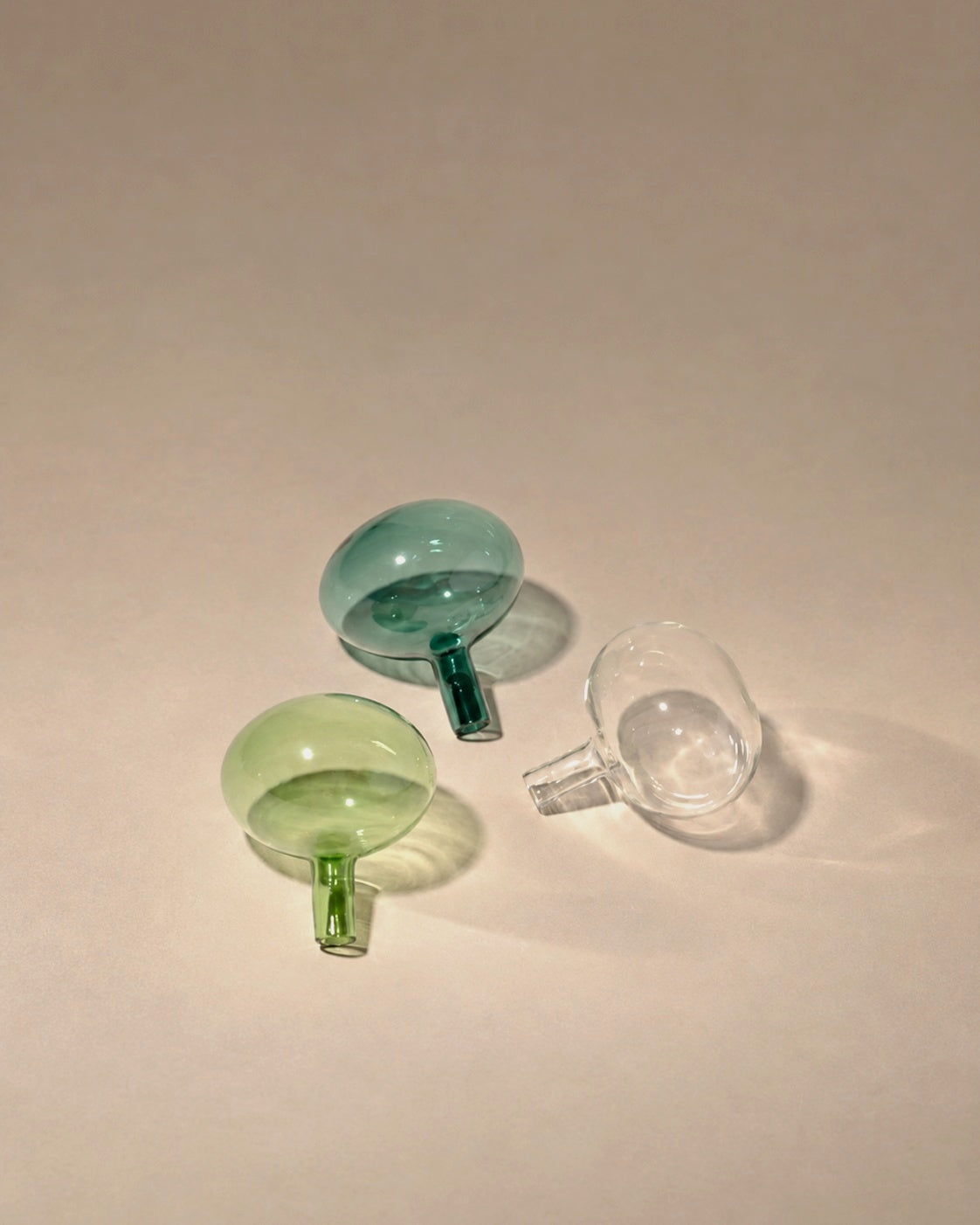 Entracte Bottle Stoppers in emerald, green and grey glass, photographed in the Son of Rand studio