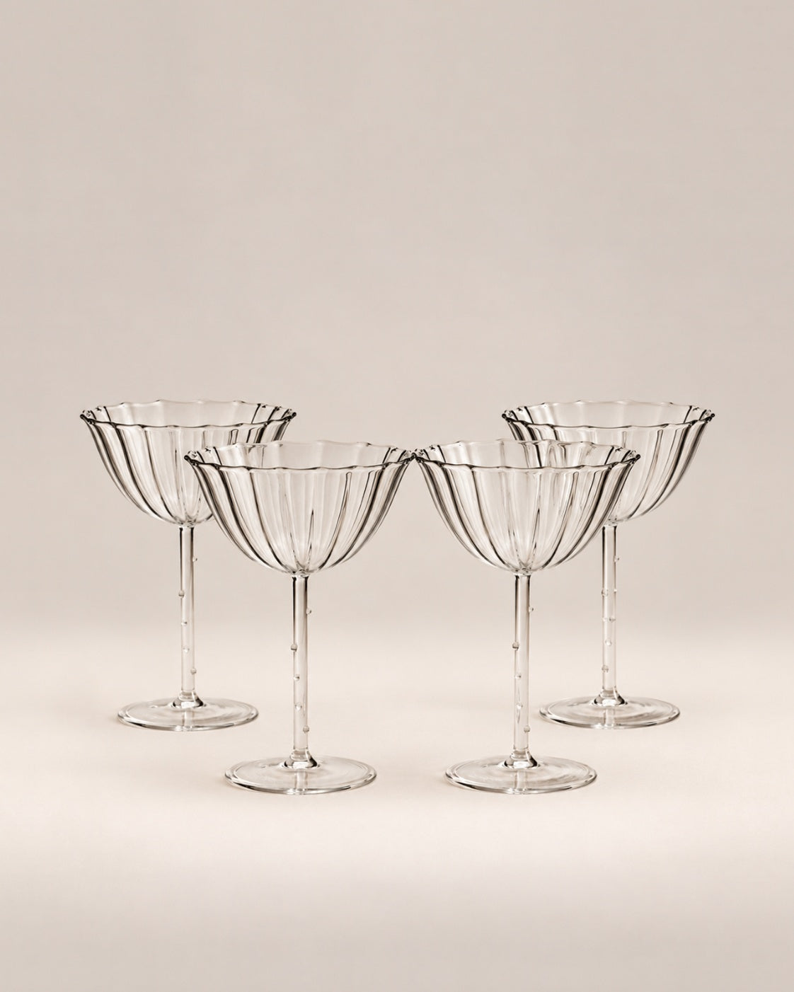 Set of four clear ribbed Cosmo coupes with scalloped rims, photographed in the Son of Rand studio