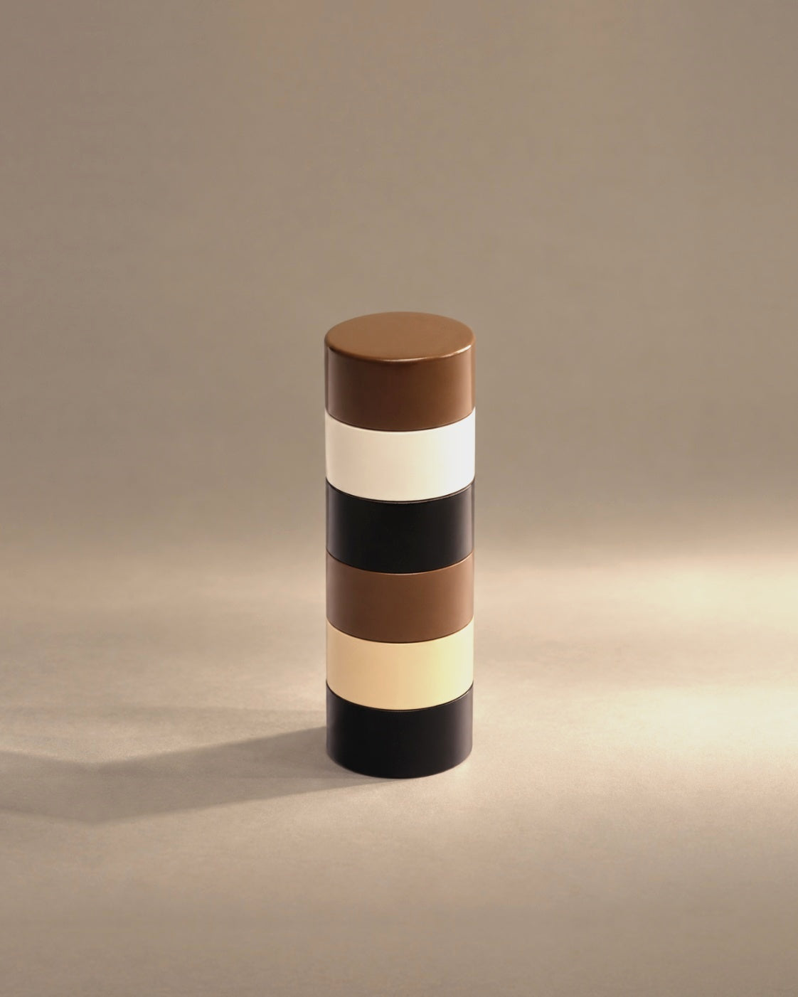 Dimes pepper mill in brown, cream, tan and black stripes, studio photo