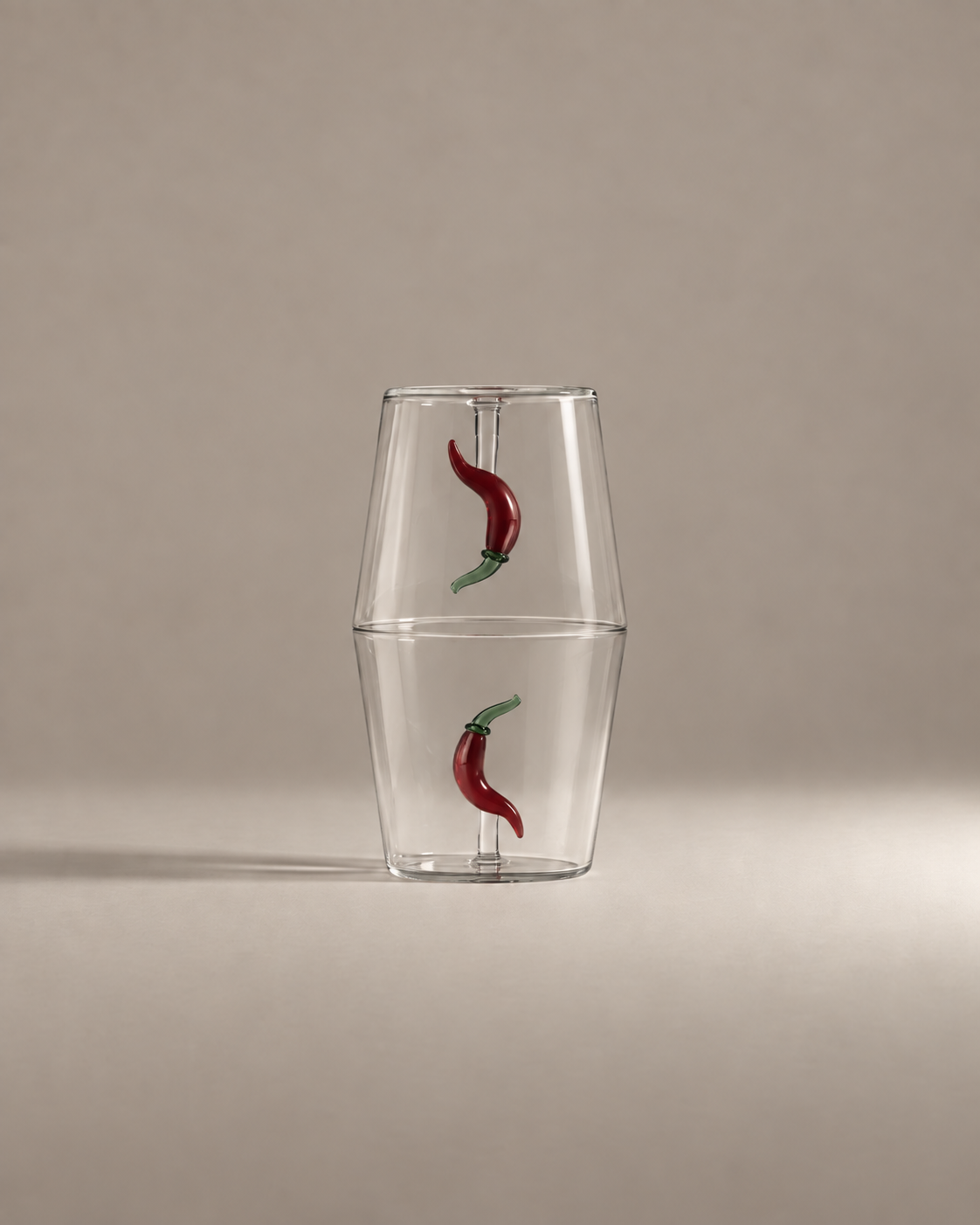 Fruit Stand Gift Set with two chili pepper glass tumblers stacked rim to rim on a warm greige background