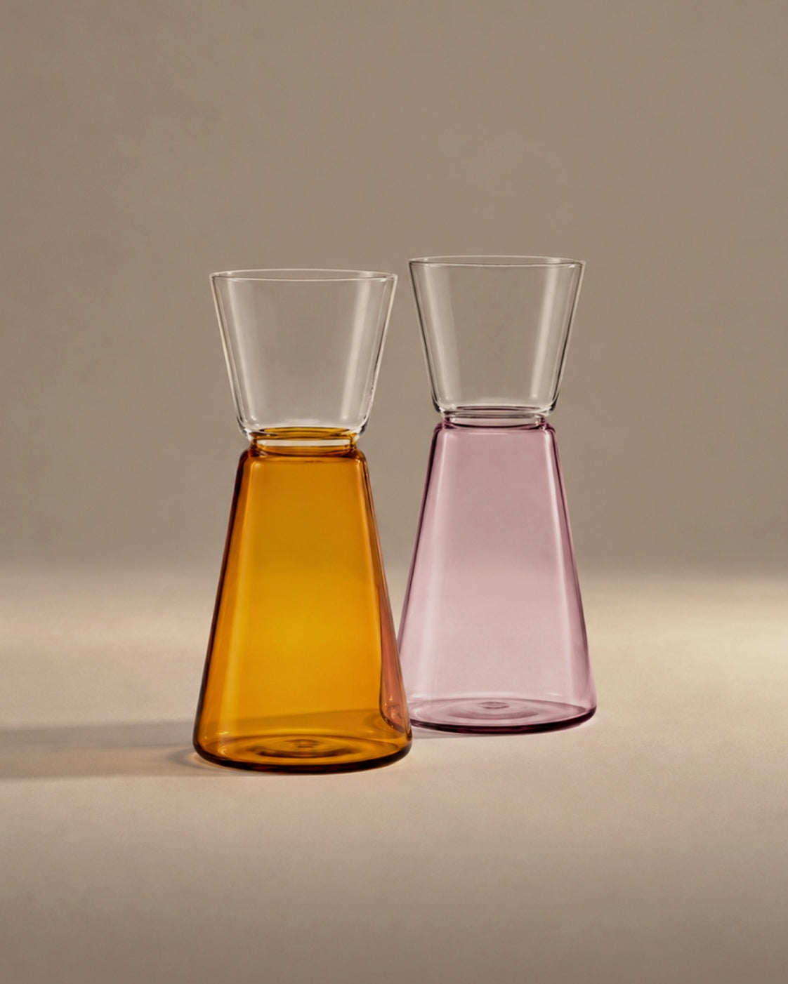 High Rise Carafe in amber and pink, each with its clear tumbler, studio photograph