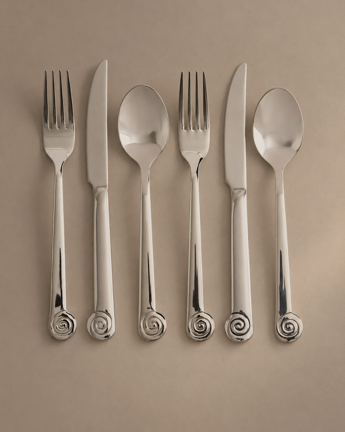 L'Escargot cutlery set with spiral snail handles, flat lay studio photo