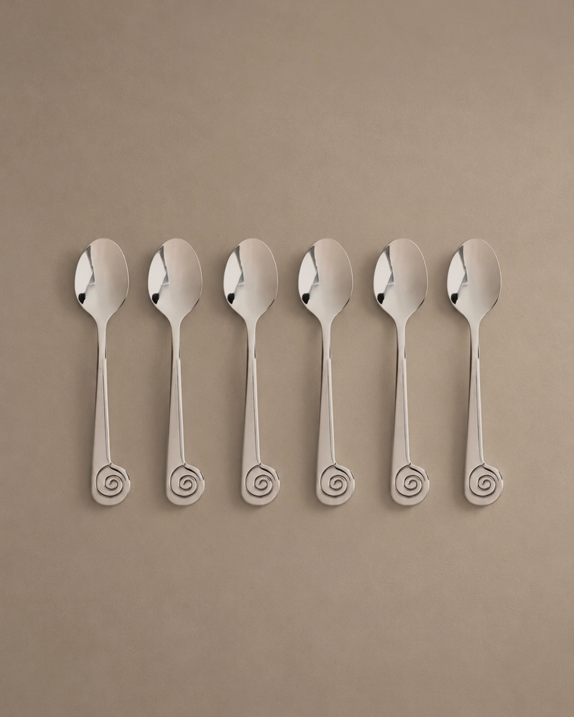 L'Escargot dessert spoons with spiral snail handles, flat lay studio photo