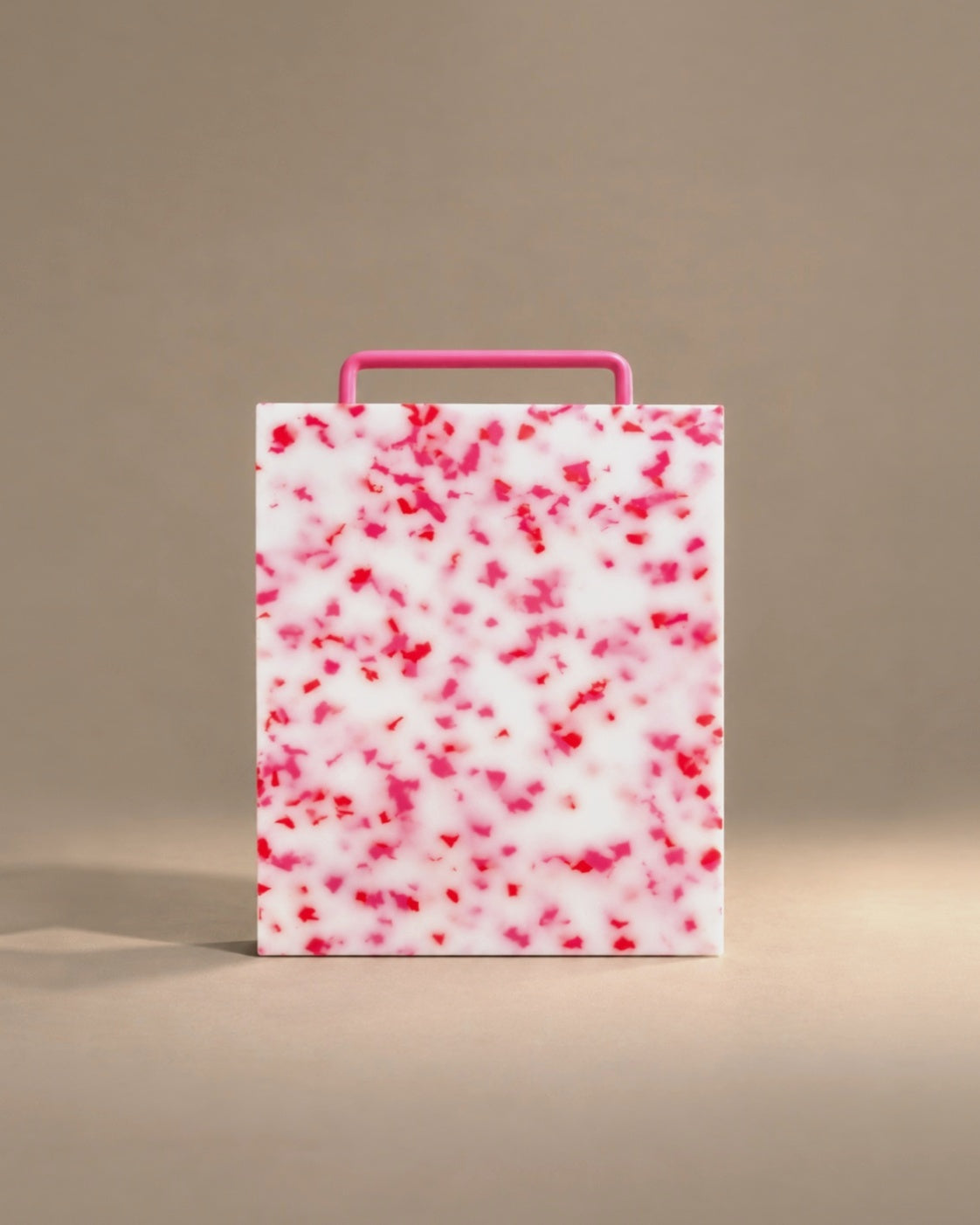Monochromatic cutting board in pink, studio photo
