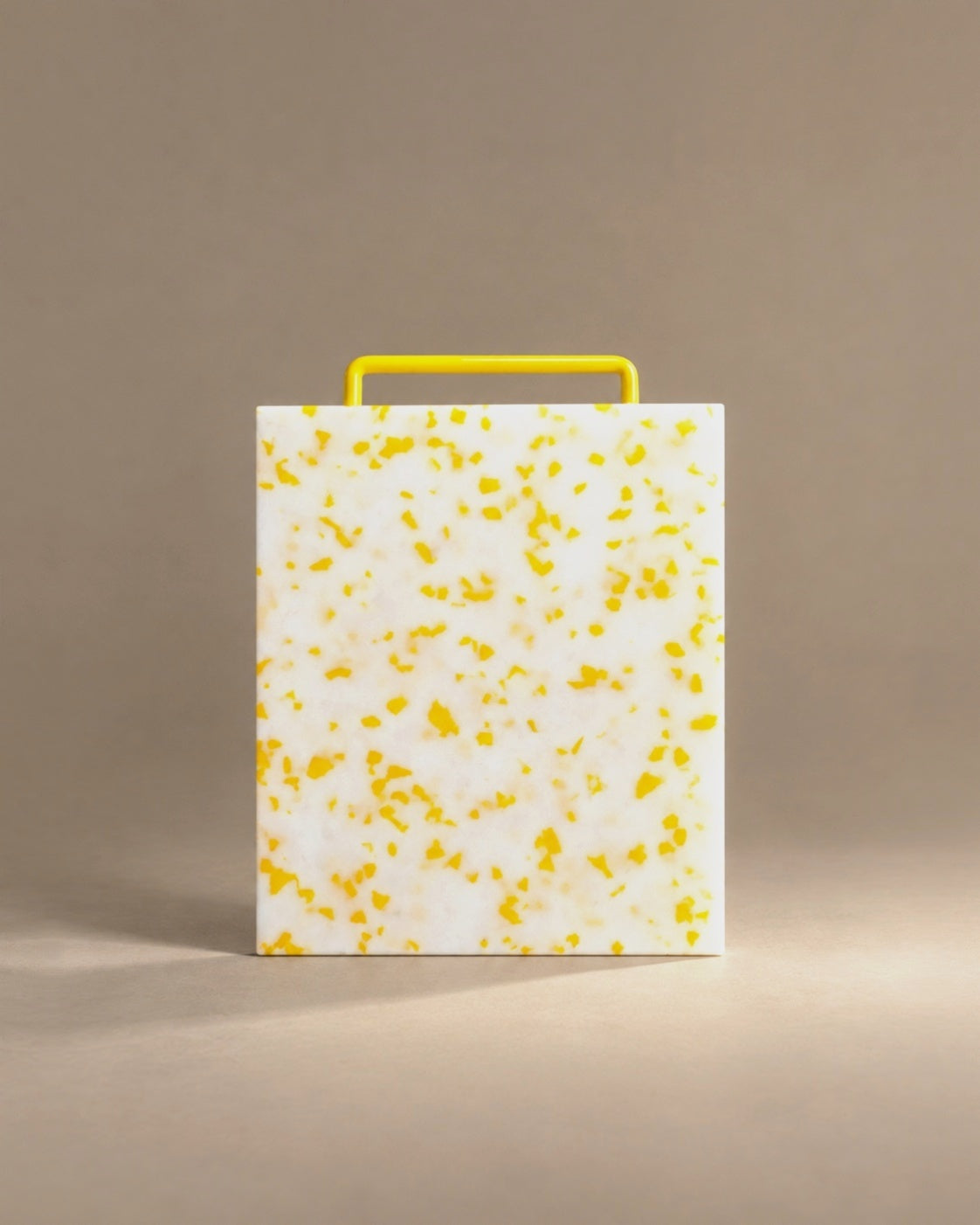 Monochromatic cutting board in yellow, studio photo