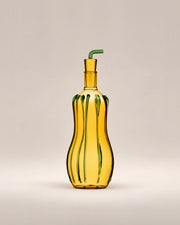 Oil Bottle Zucchini, an amber glass bottle with green stripes and a green spout, photographed in the Son of Rand studio