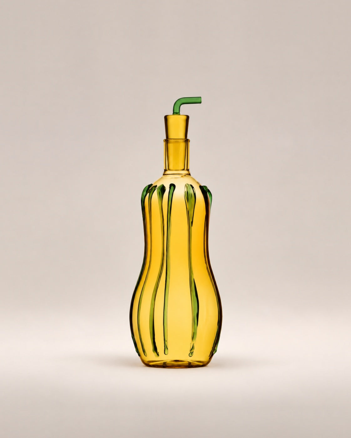 Oil Bottle Zucchini, an amber glass bottle with green stripes and a green spout, photographed in the Son of Rand studio