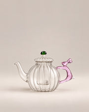 Clear ribbed glass teapot with a pink rabbit handle and green mushroom knob, photographed in the Son of Rand studio