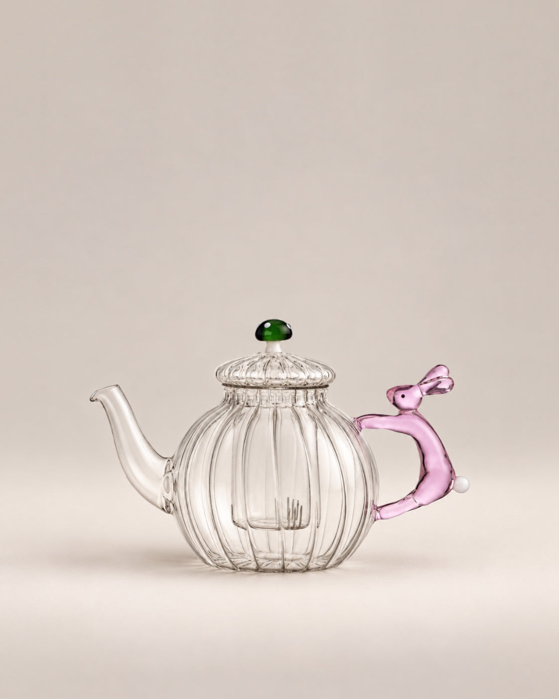 Clear ribbed glass teapot with a pink rabbit handle and green mushroom knob, photographed in the Son of Rand studio