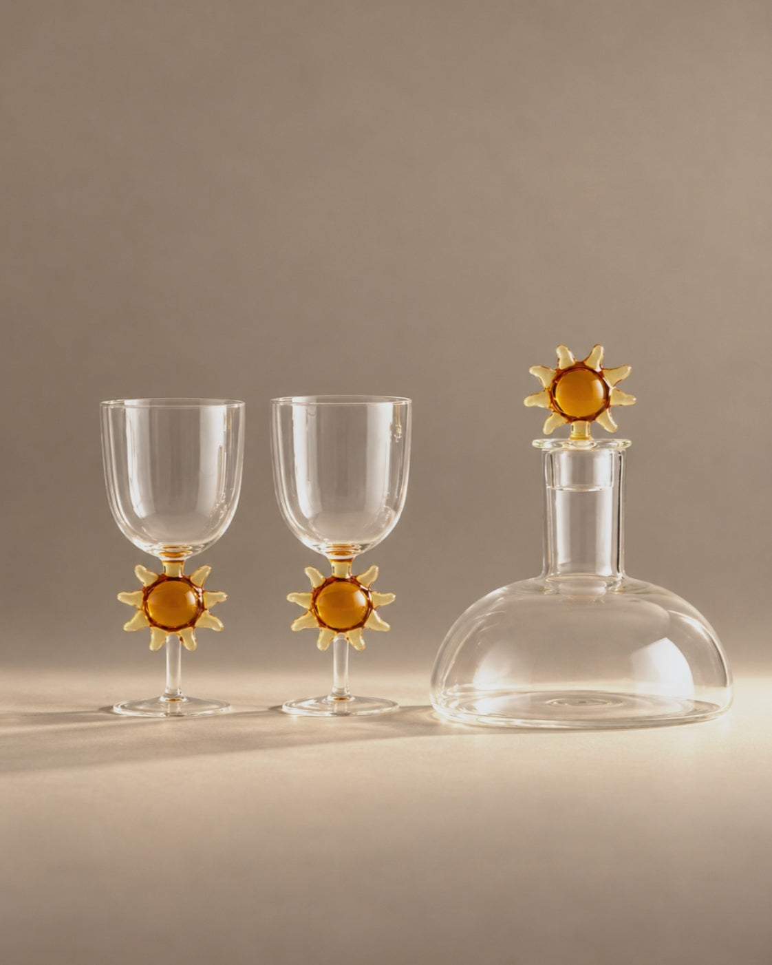 Soleil gift set wine glasses and carafe with amber suns, studio photo