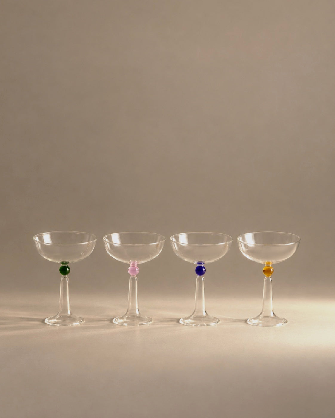 Tassel champagne coupe set of four with coloured glass beads, studio photo