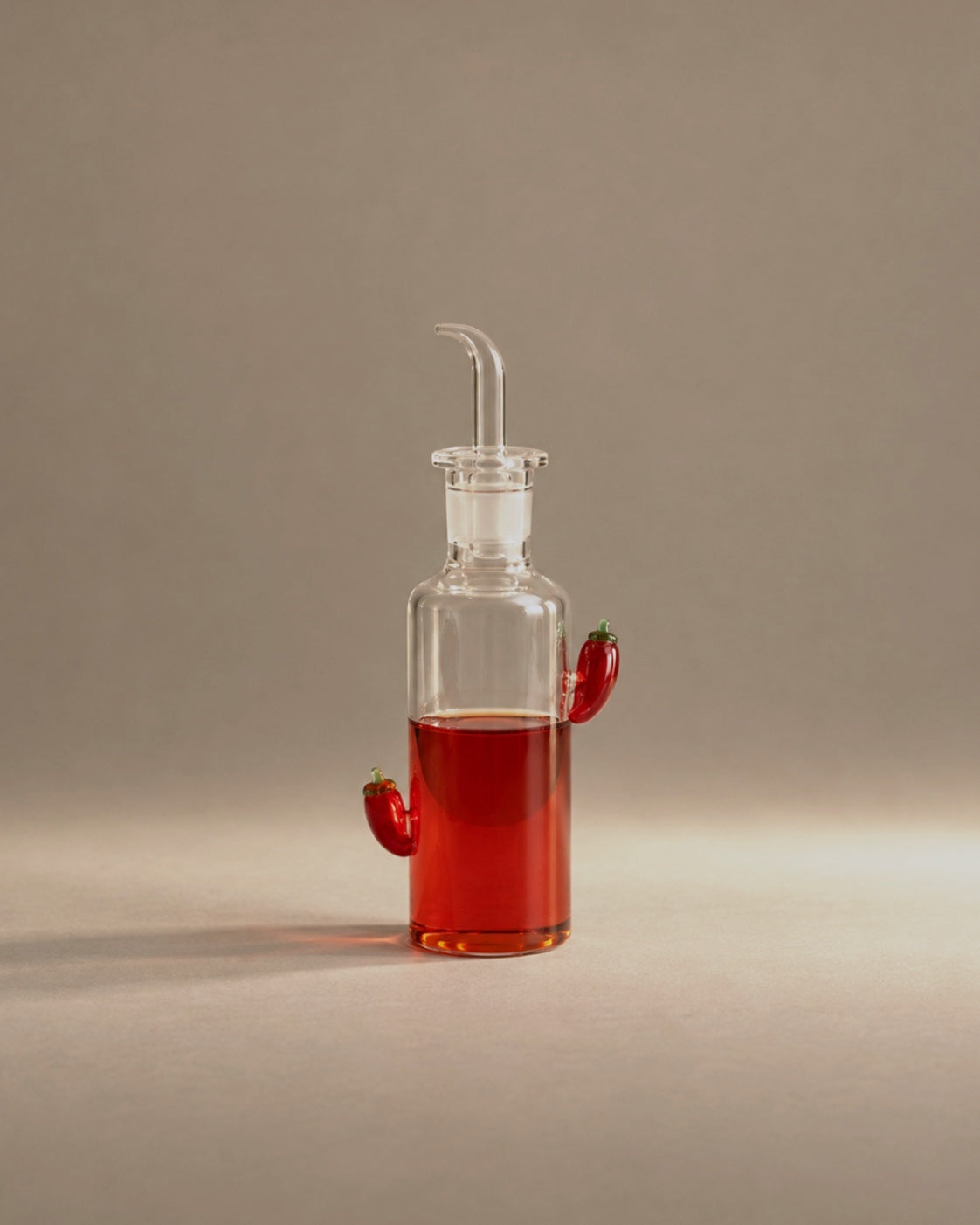 The Chili Bottle with glass chili peppers, studio photograph