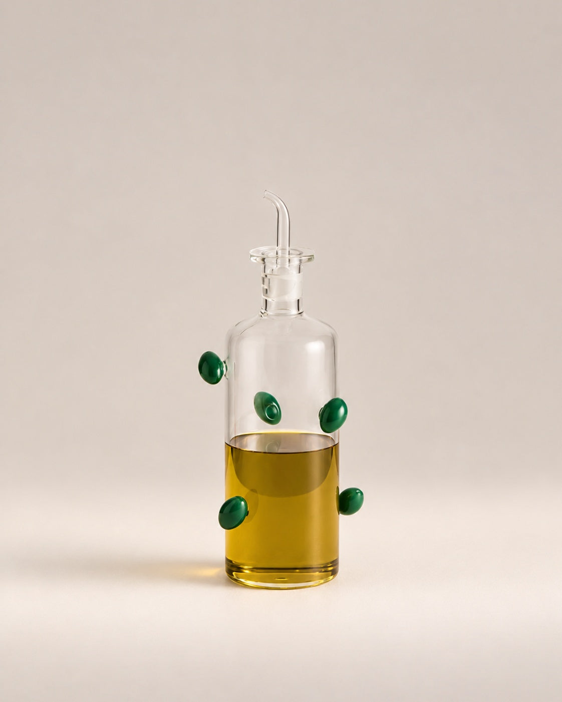 The Olive Bottle, a clear glass oil bottle with green glass olives, photographed in the Son of Rand studio