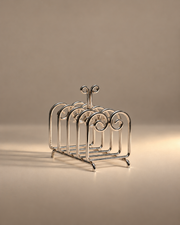 The Porter toast rack by Sophie Lou Jacobsen, with curled metal dividers in warm light