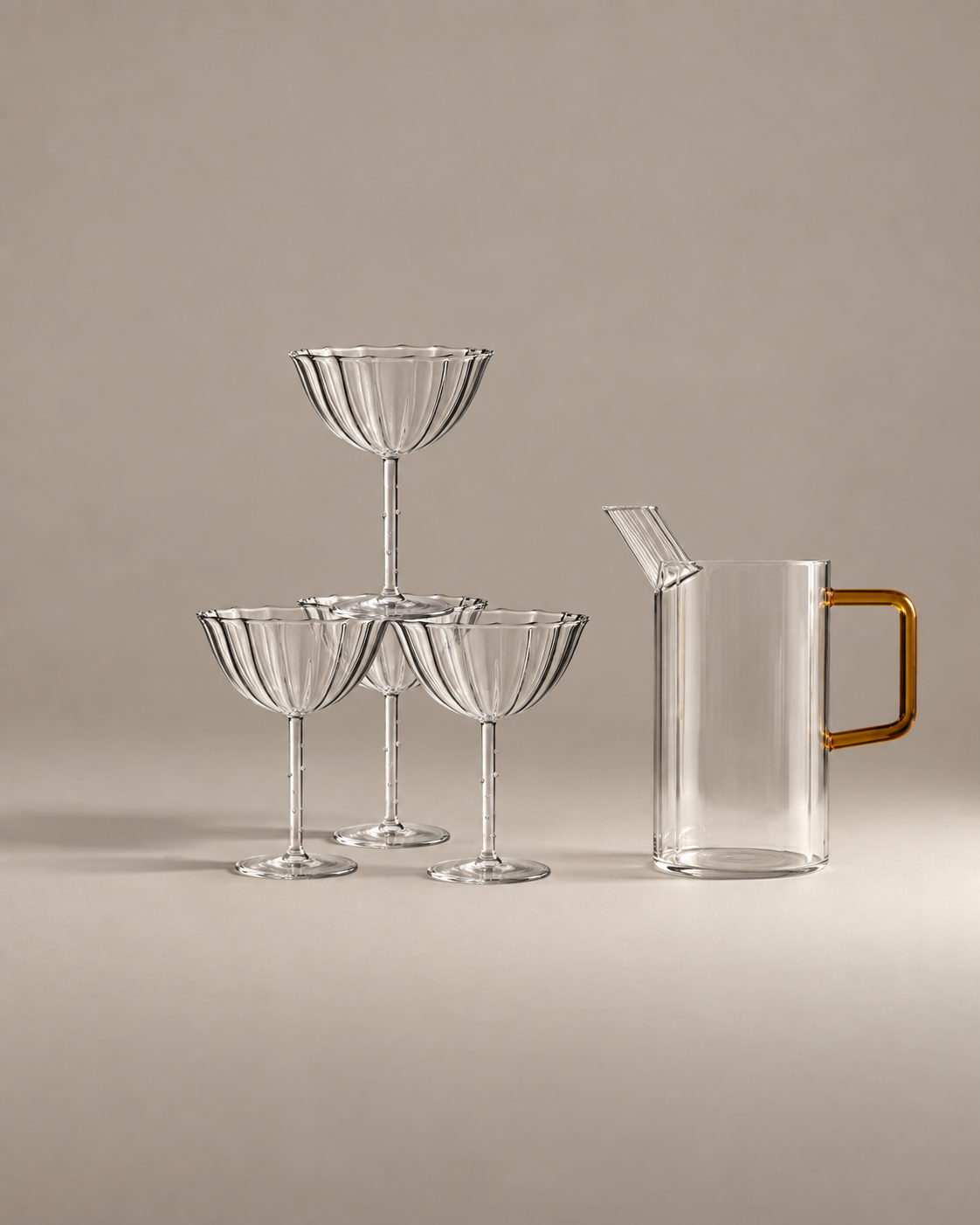 Toast to Them Gift Set: four fluted glass coupes stacked as a champagne tower beside a glass jug