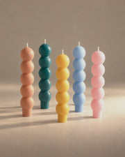 Volute candles in sable, teal, miel, sky and pink, photographed in the Son of Rand studio